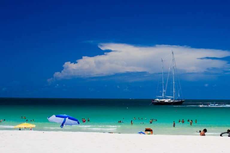 Blue Ocean Beach and sky with Sailboat